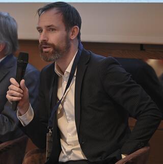 A man speaks into a microphone