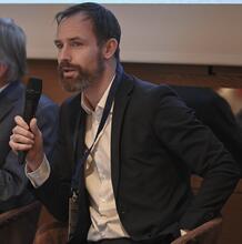 A man speaks into a microphone